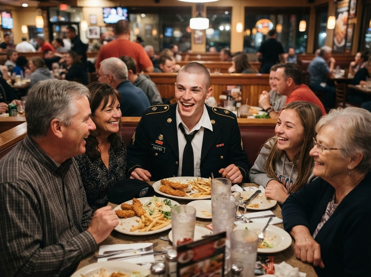 A new soldier laughing at a family dinner table